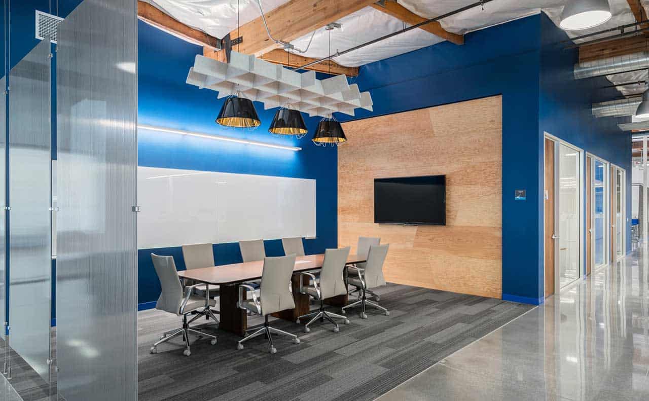 Open Meeting Room with Ergonomic Chairs, TV, and Meeting Table