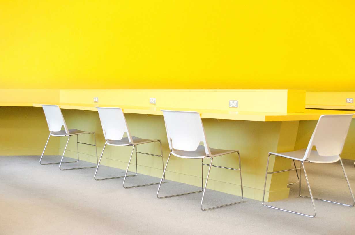 Laptop Bar with White Flexible Haworth Chairs and Yellow Workbench