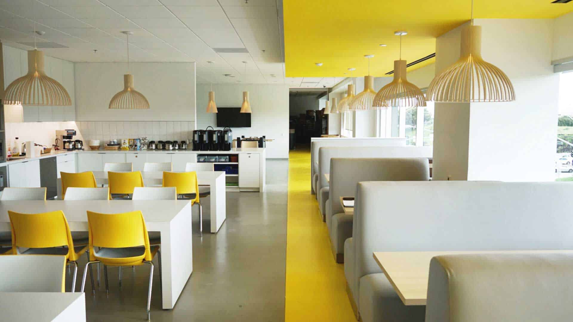 Colorful Open Office Area with Chairs, Tables, and Booths