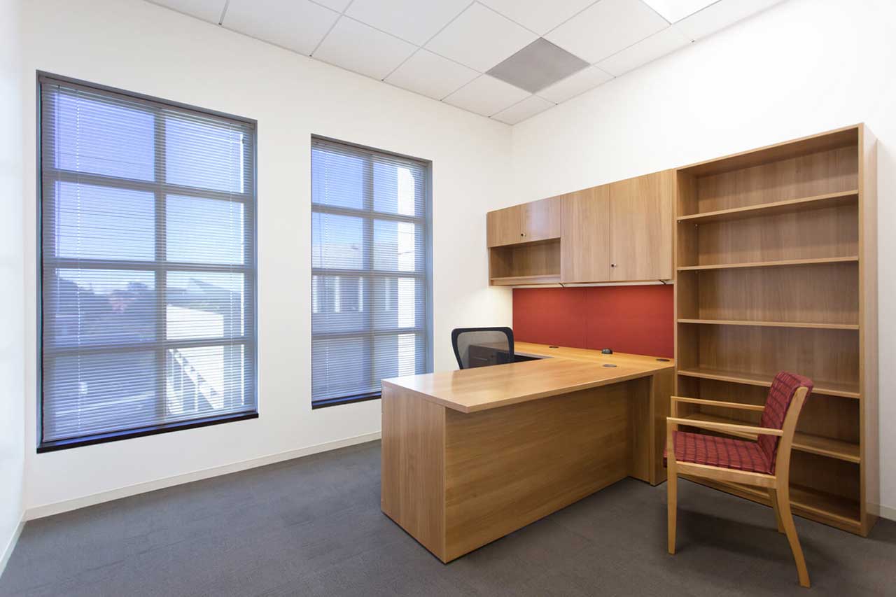 A private office with a desk, cabinets, and chairs inside USC's VPD hall