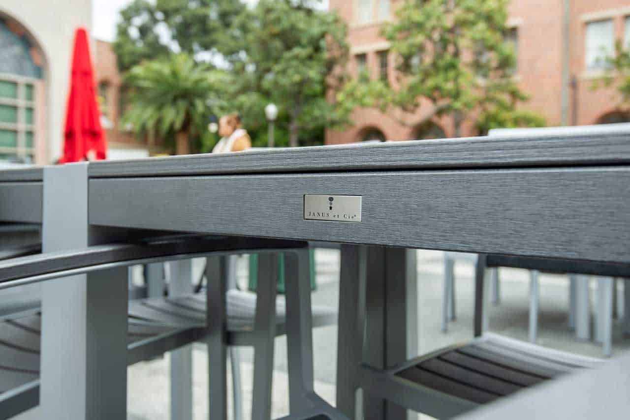 A closeup of a durable outdoor table and seating designed for high traffic