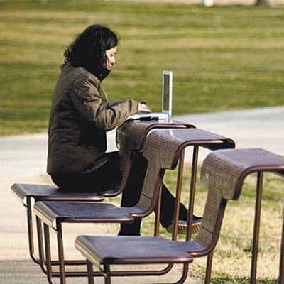 a woman sitting outdoor while working