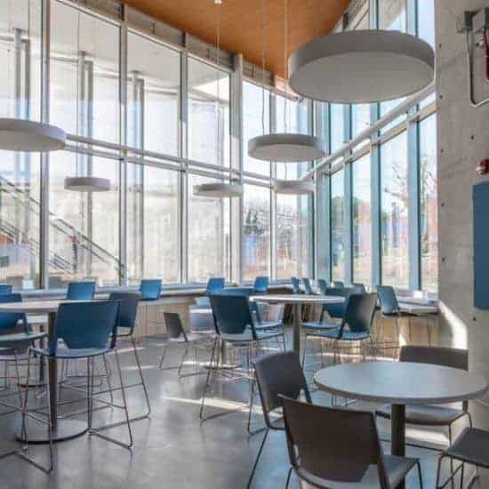 Modern Student Cafeteria Design with Chairs, Tables, and Large Windows