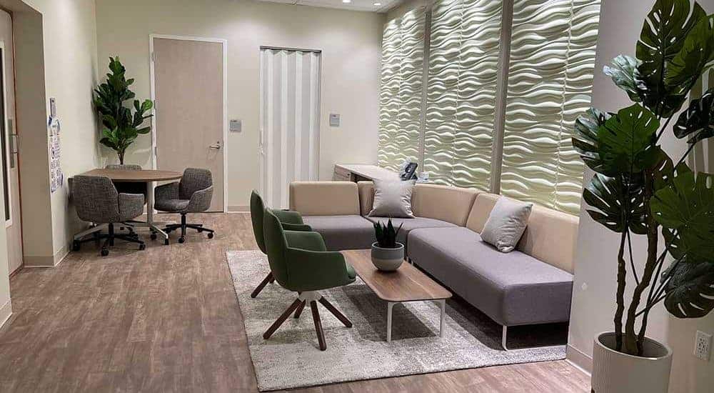 Medical Facility Waiting Area Design showing couch, chairs and table for USC Michelson Center