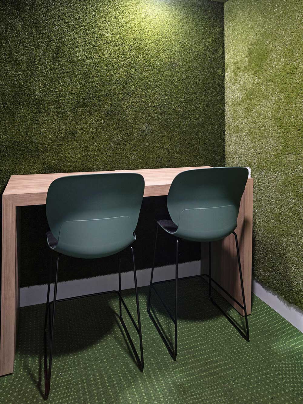 Private student study space design with green chairs and laptop stand