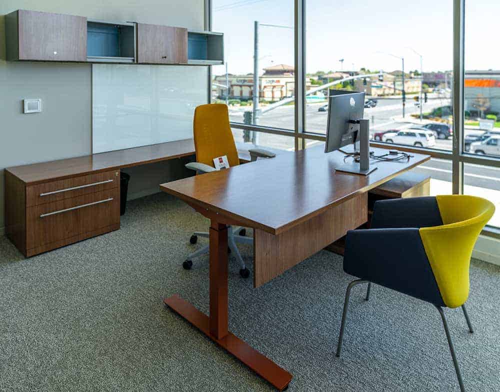 Contemporary credit union private office design features ergonomic seating and wood desks