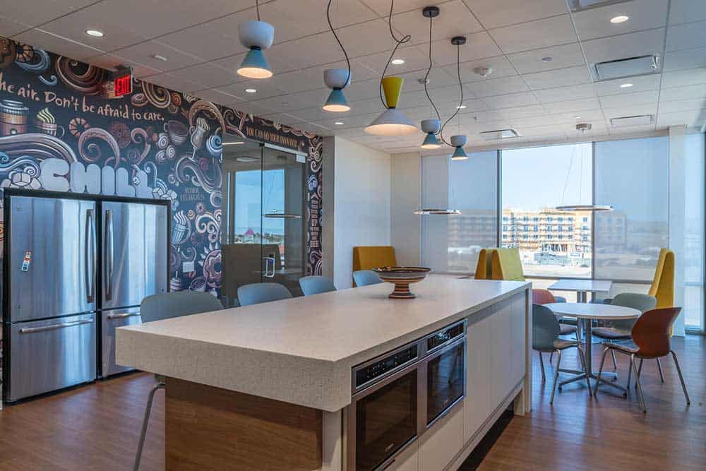 Modern break room featuring colorful chairs and lamps