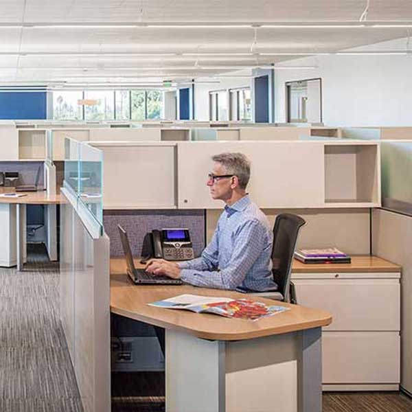 Man sitting at desk in Government Office; SBE Furniture Dealer