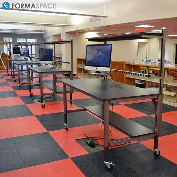 Maker space using Formaspace technology lab tables with casters, power strips, shelving and monitor support.