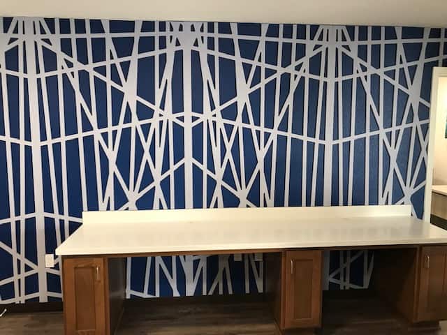 Custom built-in millwork counter in the Community Center in front of the Zintra Acoustic Panels in the Monsoon pattern by MDC Interior Solutions.