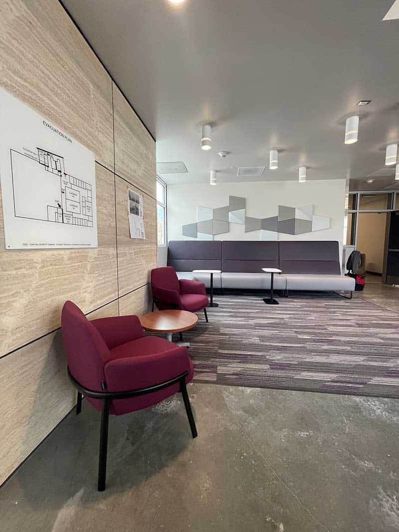 Image of lounge chairs, cafe tables and wall seating in a 4th floor study area.