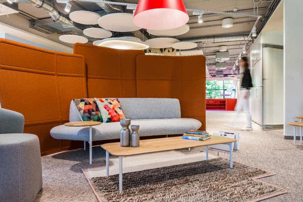Haworth’s Collection sofa, chair, table, and privacy panels show a cozy collaboration area..