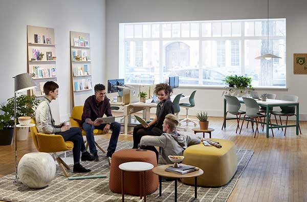 Picture of a flexible, informal workspace with several employees collaborating.